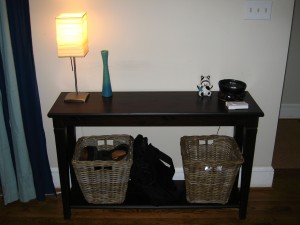 sofa table with lamp and baskets